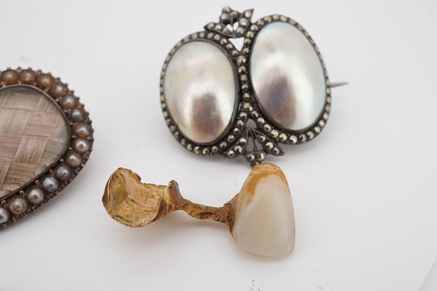 Assorted jewellery including a 19th century mourning brooch with plaited hair and split pearl set border, 22mm, a yellow metal mounted tooth, three marcasite set items and a paste set brooch.